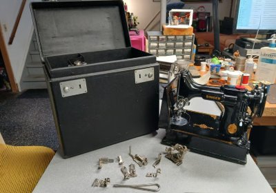A Singer Featherweight opened up for a tune up with cleaned parts laid out